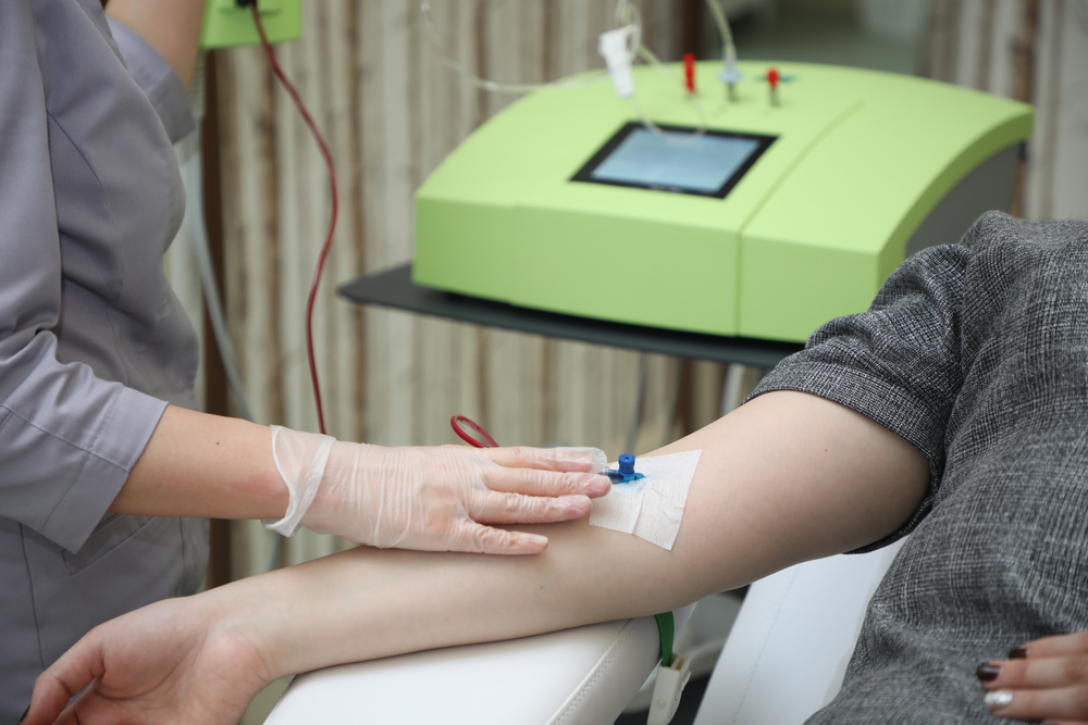 Woman undergoing blood ozone therapy treatment, experiencing the benefits of ozone-infused blood transfusion.